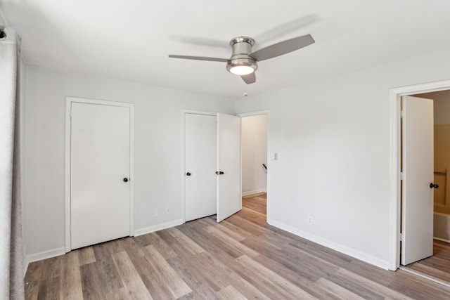 223 Edgewood Dr, Hendersonville, TN 37075 - unfurnished bedroom with two closets, baseboards, a ceiling fan, and light wood-style floors