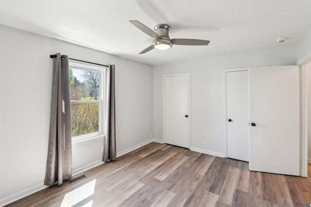 223 Edgewood Dr, Hendersonville, TN 37075 - unfurnished bedroom featuring visible vents, baseboards, two closets, and wood finished floors