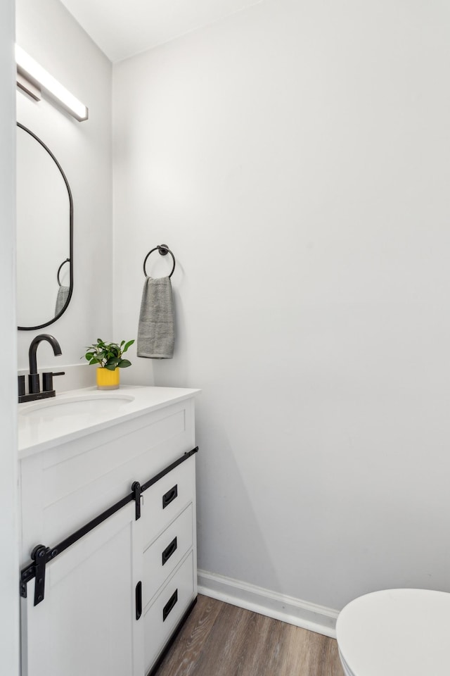 223 Edgewood Dr, Hendersonville, TN 37075 - half bathroom with vanity, baseboards, toilet, and wood finished floors
