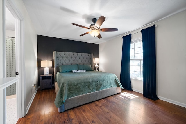 bedroom featuring wood finished floors, ceiling fan, and baseboards