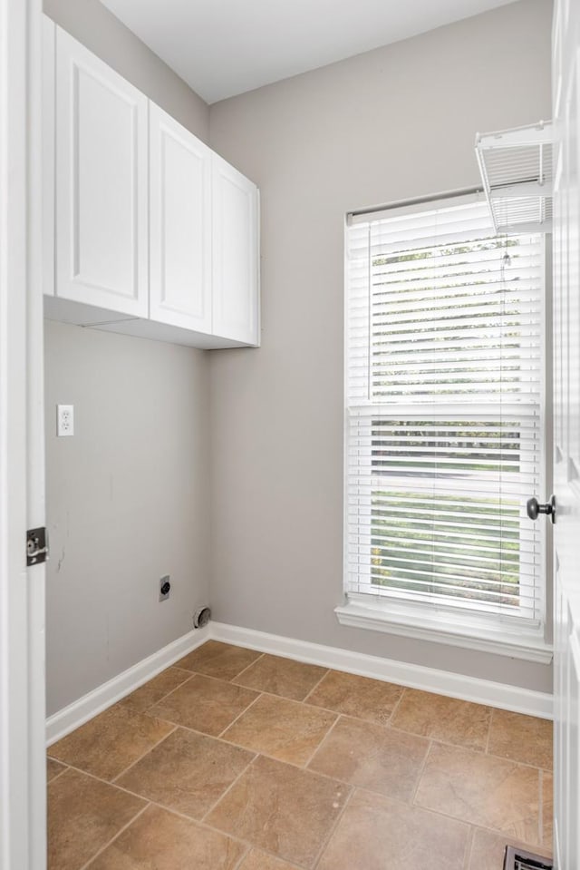 laundry area with cabinet space, baseboards, and hookup for an electric dryer