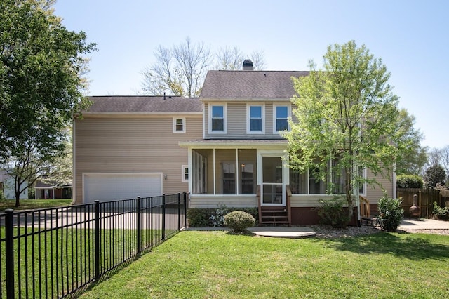 back of property featuring a chimney, a fenced backyard, a yard, a garage, and a sunroom