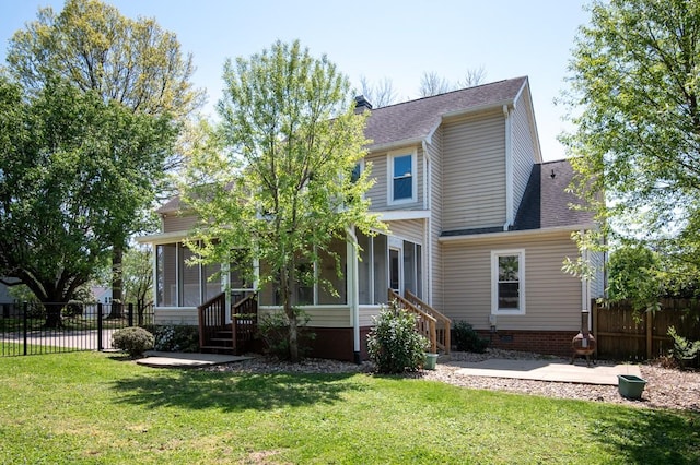 view of front of house with a patio area, a front lawn, a shingled roof, fence, and a sunroom