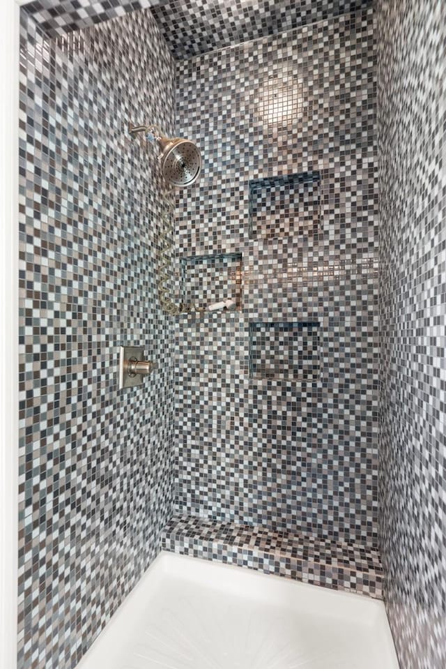 bathroom with tiled shower