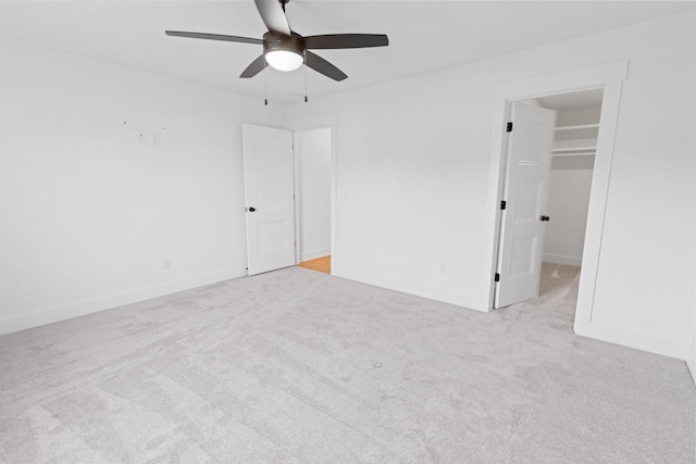 6913 Pembrooke Farms Dr, Murfreesboro, TN 37129 - unfurnished bedroom featuring baseboards, a spacious closet, light colored carpet, a ceiling fan, and a closet