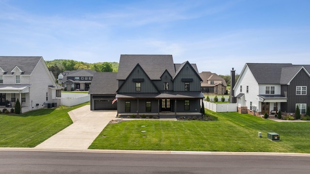 6913 Pembrooke Farms Dr, Murfreesboro, TN 37129 - view of front facade with concrete driveway, fence, a residential view, and board and batten siding