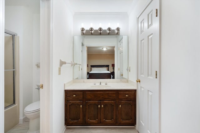 bathroom with toilet, crown molding, vanity, and ensuite bath