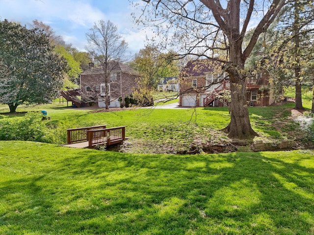 surrounding community featuring an attached garage and a yard