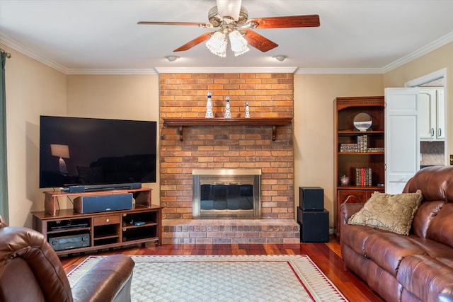 living room featuring crown molding, ceiling fan, wood finished floors, and a fireplace