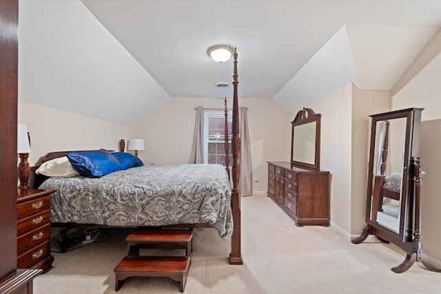 carpeted bedroom featuring baseboards and vaulted ceiling