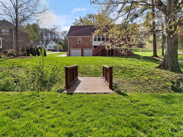 view of yard featuring a garage and stairway
