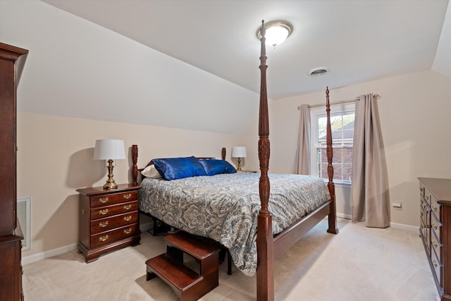 bedroom featuring light carpet, visible vents, baseboards, and vaulted ceiling