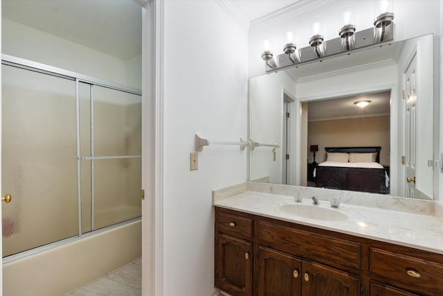 ensuite bathroom featuring bath / shower combo with glass door, vanity, crown molding, and connected bathroom