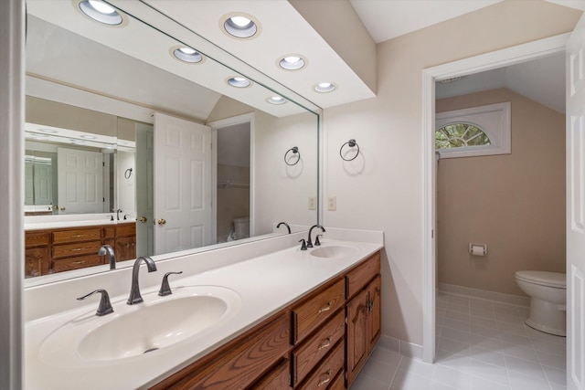 bathroom with toilet, a sink, vaulted ceiling, and recessed lighting