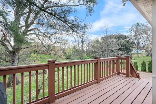 wooden deck featuring a yard