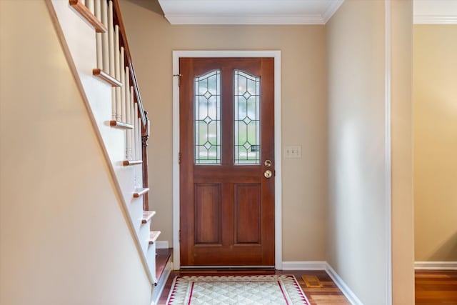 entryway with crown molding, wood finished floors, and stairs