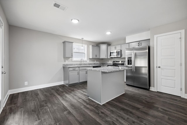 51 Gratton Ests, Clarksville, TN 37043 - kitchen with appliances with stainless steel finishes, gray cabinetry, a kitchen island, baseboards, and dark wood-type flooring