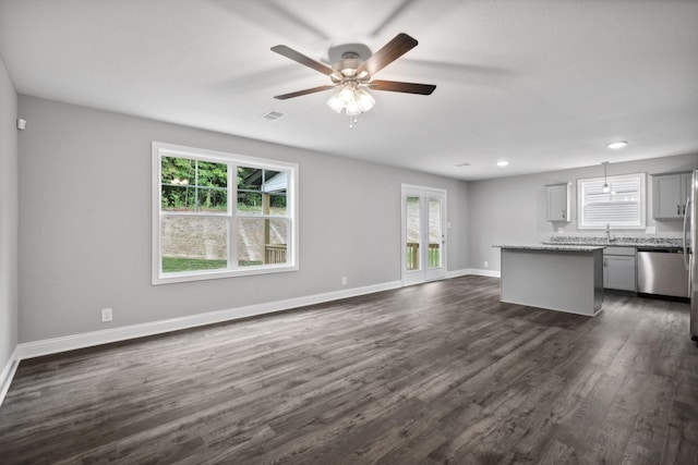 51 Gratton Ests, Clarksville, TN 37043 - unfurnished living room featuring plenty of natural light, dark wood finished floors, ceiling fan, and baseboards