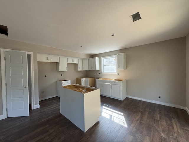 51 Gratton Ests, Clarksville, TN 37043 - kitchen with a kitchen island, dark wood-style flooring, baseboards, and white cabinets