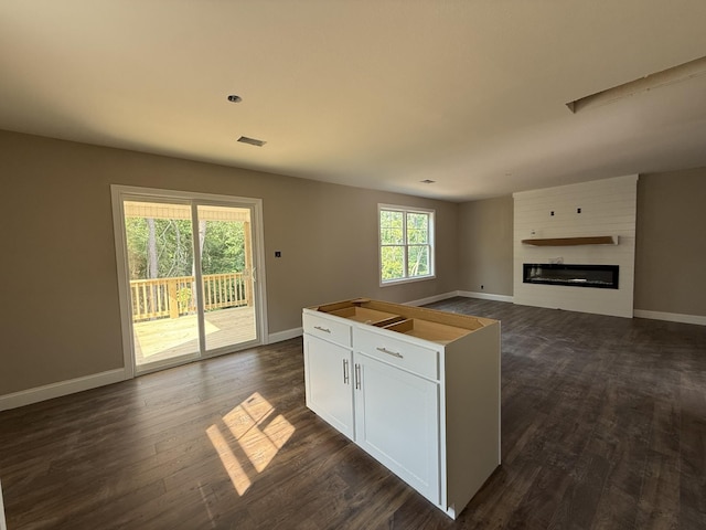 51 Gratton Ests, Clarksville, TN 37043 - kitchen featuring open floor plan, dark wood-style floors, baseboards, and a large fireplace