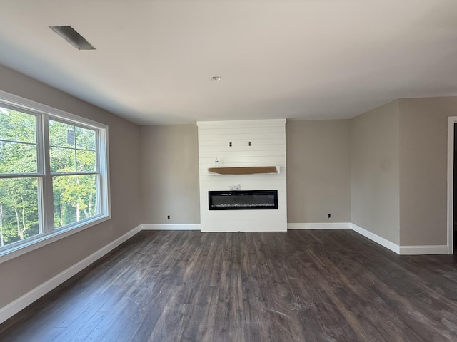 51 Gratton Ests, Clarksville, TN 37043 - unfurnished living room with baseboards, dark wood-style floors, and a large fireplace