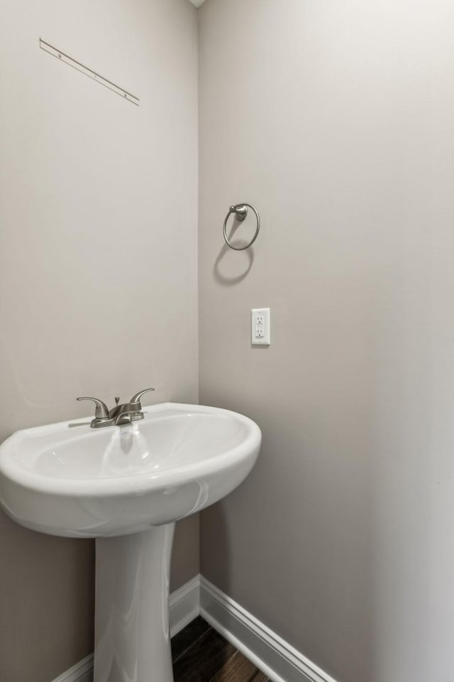 48 Gratton Ests, Clarksville, TN 37043 - bathroom featuring baseboards, a sink, and wood finished floors