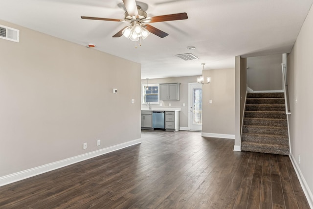 48 Gratton Ests, Clarksville, TN 37043 - unfurnished living room with dark wood-type flooring, visible vents, stairway, and ceiling fan with notable chandelier