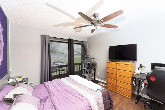 bedroom featuring wood finished floors, ceiling fan, baseboards, and access to exterior