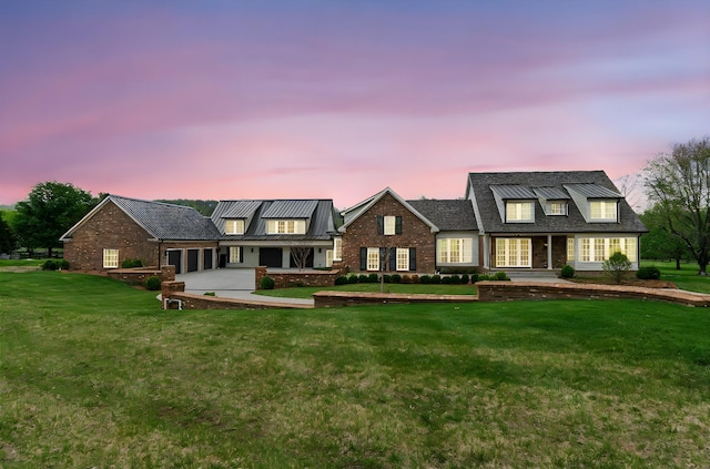 4535 Peytonsville Rd, Franklin, TN 37064 - view of front of house featuring brick siding, metal roof, a yard, and a garage