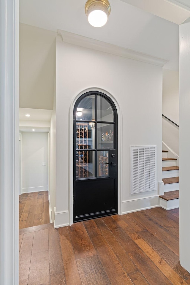 4535 Peytonsville Rd, Franklin, TN 37064 - foyer featuring visible vents, baseboards, arched walkways, stairs, and wood-type flooring