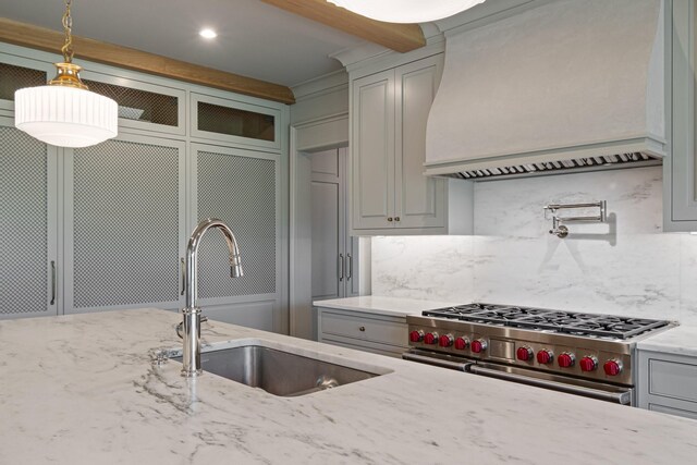 4535 Peytonsville Rd, Franklin, TN 37064 - kitchen with custom range hood, light stone countertops, decorative backsplash, high end stainless steel range, and a sink