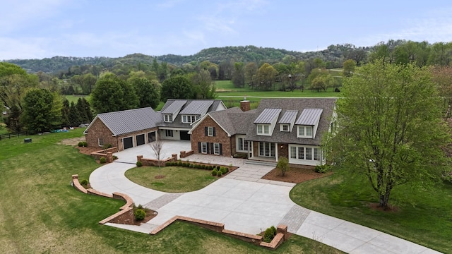 4535 Peytonsville Rd, Franklin, TN 37064 - view of front facade featuring a standing seam roof, metal roof, a front lawn, and curved driveway