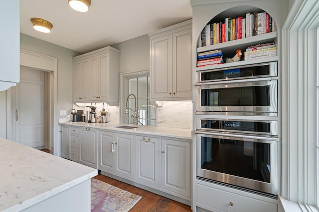 4535 Peytonsville Rd, Franklin, TN 37064 - kitchen with white cabinets, a sink, double oven, light wood finished floors, and backsplash