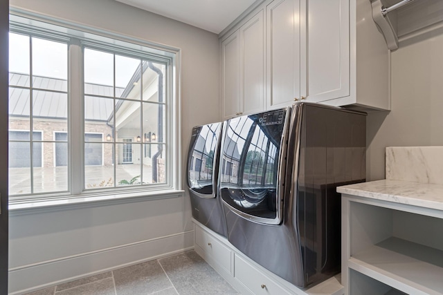 4535 Peytonsville Rd, Franklin, TN 37064 - laundry area featuring stone finish floor, baseboards, washing machine and clothes dryer, and cabinet space