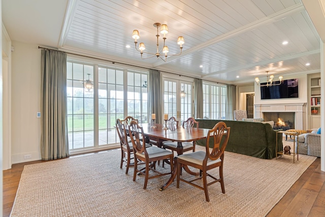 4535 Peytonsville Rd, Franklin, TN 37064 - dining room with an inviting chandelier, a lit fireplace, ornamental molding, hardwood / wood-style floors, and baseboards