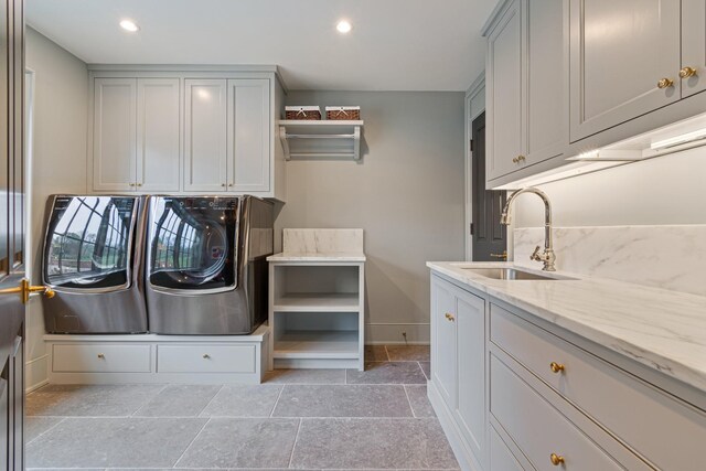 4535 Peytonsville Rd, Franklin, TN 37064 - washroom with baseboards, recessed lighting, washing machine and dryer, cabinet space, and a sink