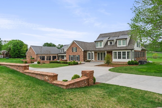 4535 Peytonsville Rd, Franklin, TN 37064 - view of front of home featuring brick siding, cooling unit, metal roof, and a standing seam roof