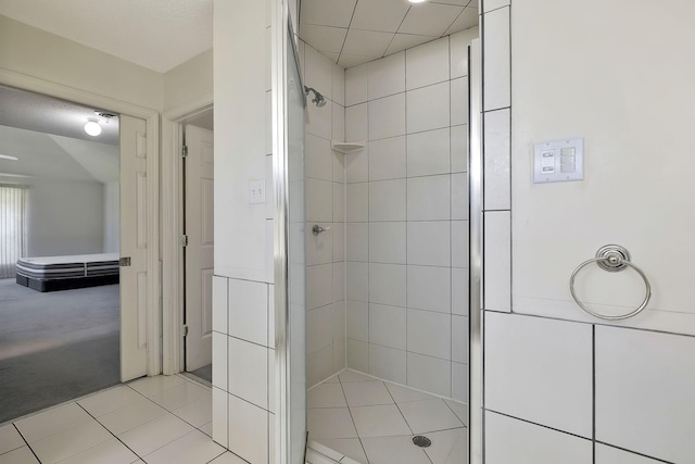 bathroom featuring a tile shower and tile patterned floors