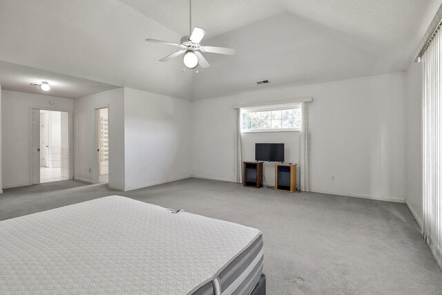 bedroom with visible vents, baseboards, light colored carpet, and vaulted ceiling