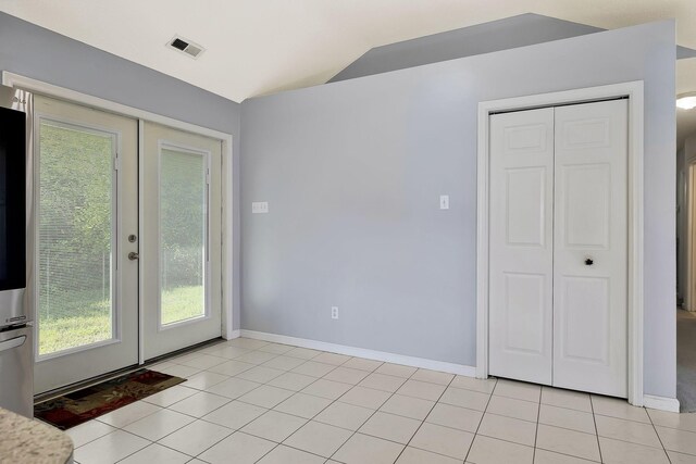 interior space with visible vents, baseboards, french doors, and lofted ceiling