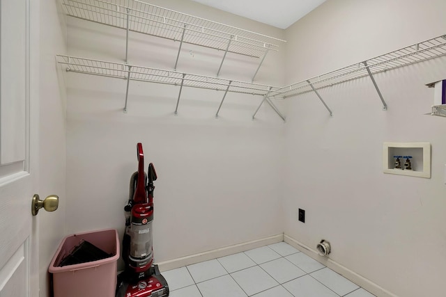 clothes washing area with baseboards, hookup for an electric dryer, laundry area, and washer hookup