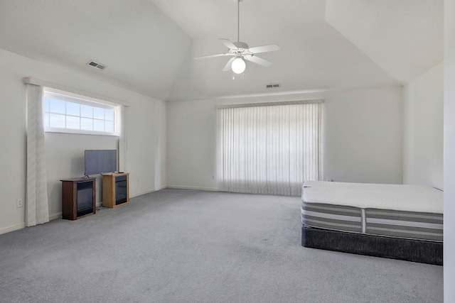 interior space with visible vents, ceiling fan, vaulted ceiling, and carpet floors