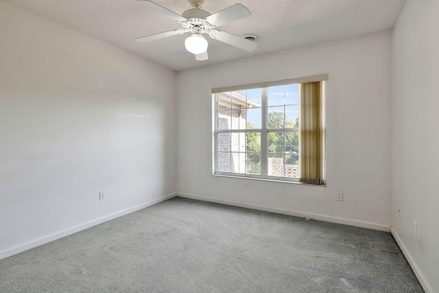 unfurnished room with a ceiling fan, carpet flooring, and a textured ceiling