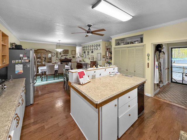 kitchen with dark wood-type flooring, ornamental molding, freestanding refrigerator, and ceiling fan with notable chandelier