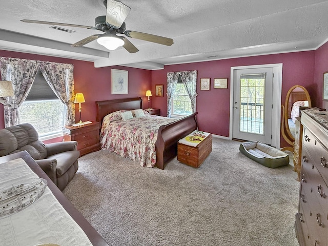 bedroom with a textured ceiling, access to exterior, carpet, and visible vents