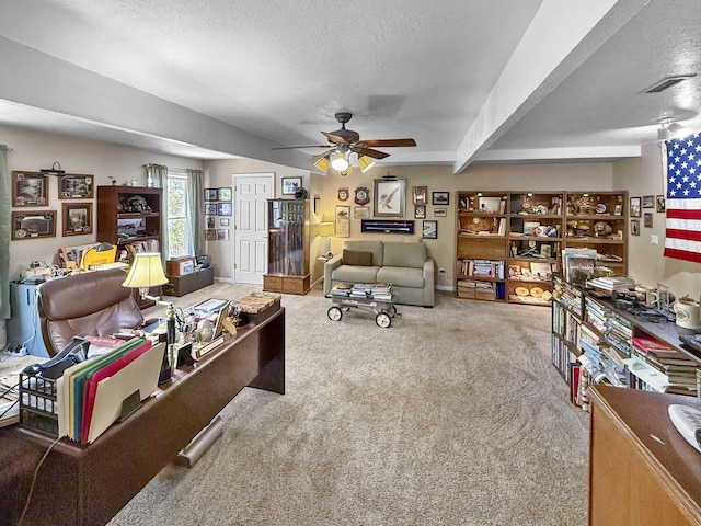 carpeted living room with a textured ceiling and ceiling fan