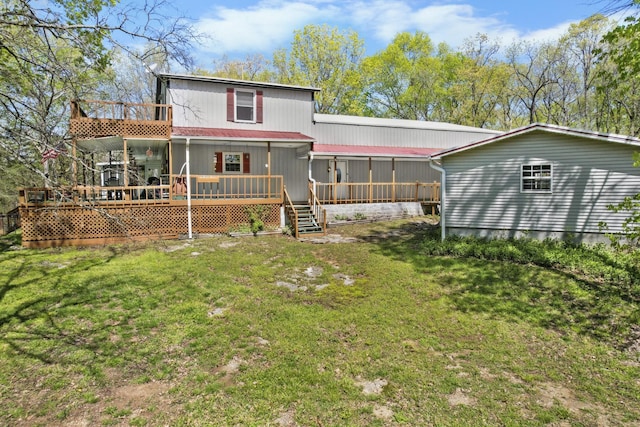 rear view of property featuring a yard and a wooden deck