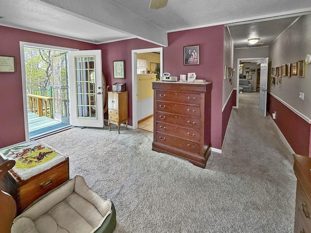 sitting room featuring baseboards, carpet, and a textured ceiling