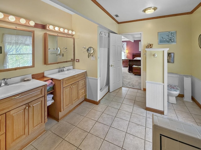 ensuite bathroom featuring ornamental molding, tile patterned floors, two vanities, and connected bathroom
