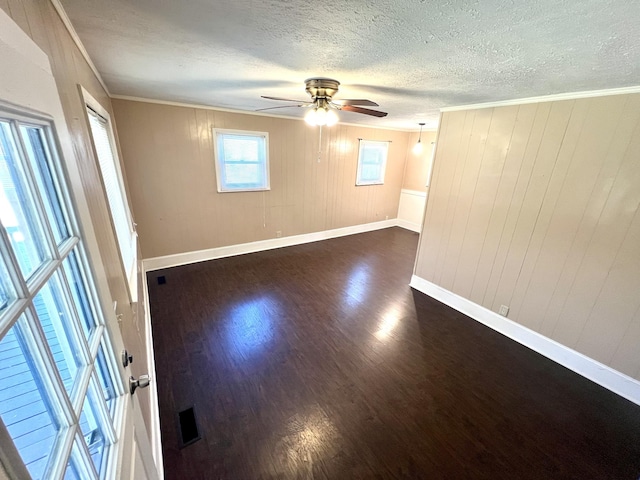 7459 Horn Tavern Rd, Fairview, TN 37062 - spare room with ceiling fan, dark wood-type flooring, a textured ceiling, ornamental molding, and baseboards